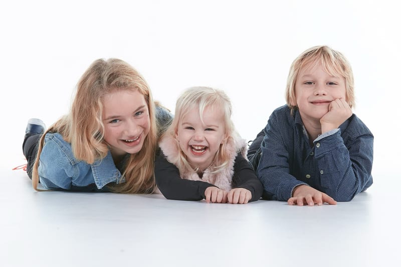 Drie kinderen lachen samen in fotostudio, studiofotografie kinderen Zoetermeer — Familieshoot Stefan Segers